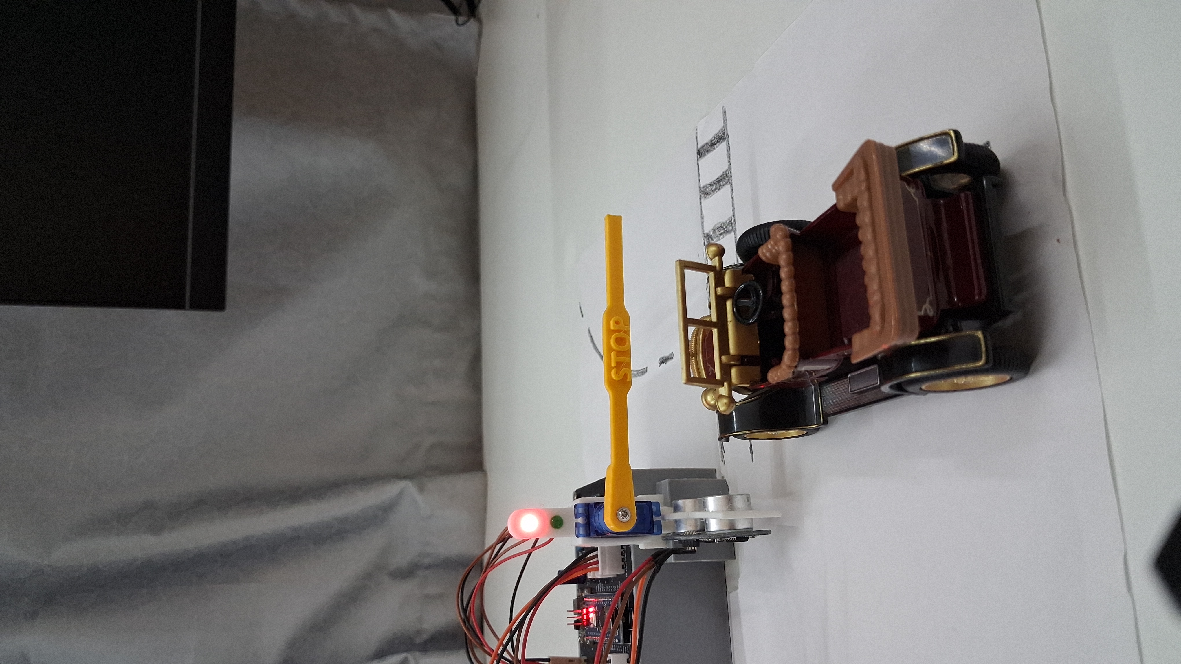 Toll Gate project: toy car stopped at a servo barrier with red LED