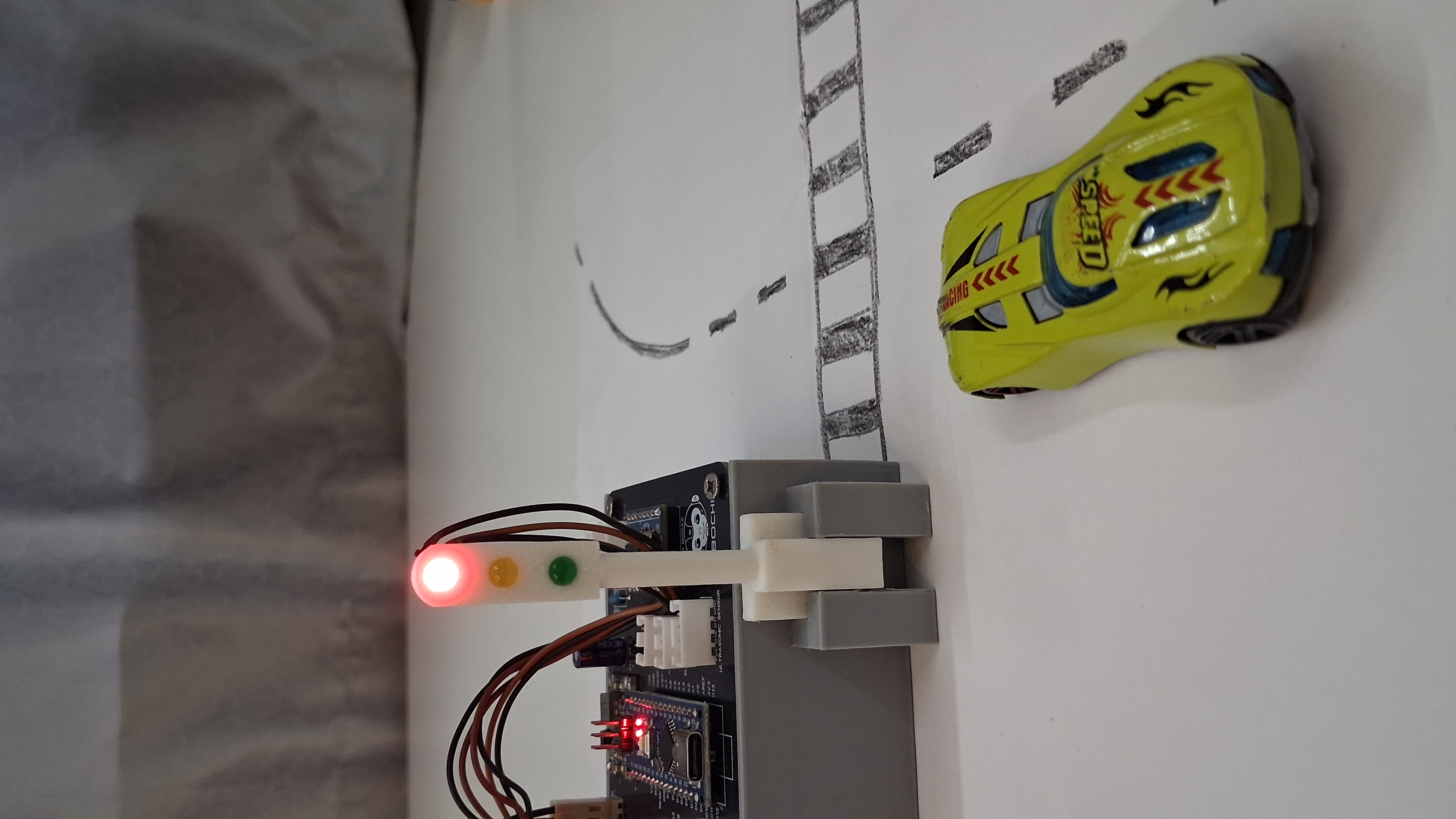 Traffic Light System project: red light on with toy car at crossing